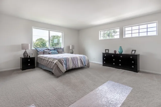 a bed room with a bed and a large window