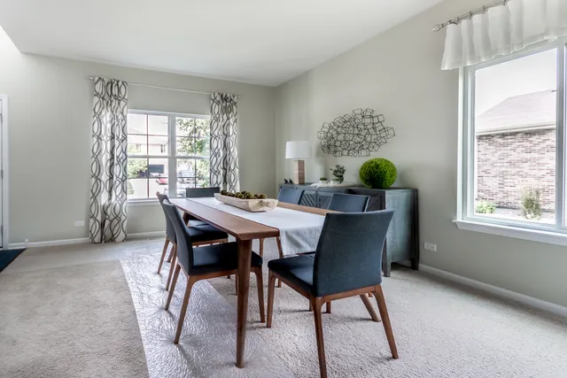 a view of a dining room with furniture window and outside view