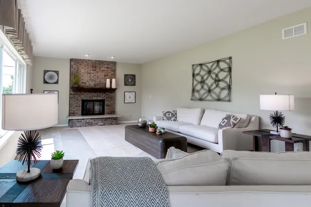 a living room with furniture and a fireplace