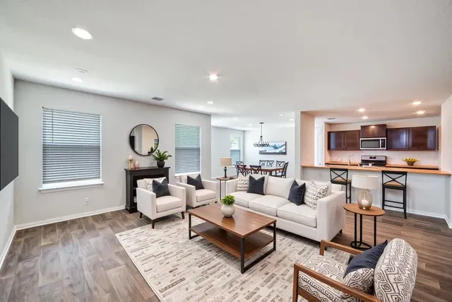 a living room with furniture and a large window
