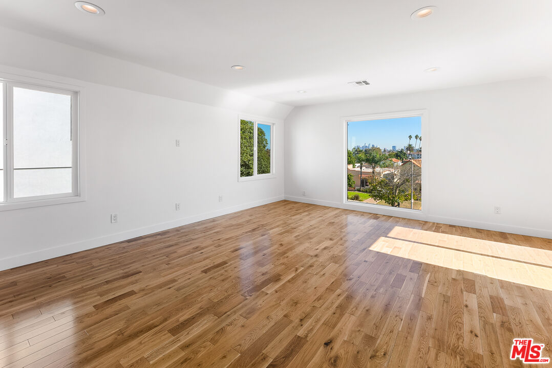 1253 South Rimpau Boulevard Los Angeles, CA 90019 - Photo 24 of 71 wooden floor in an empty room with a window