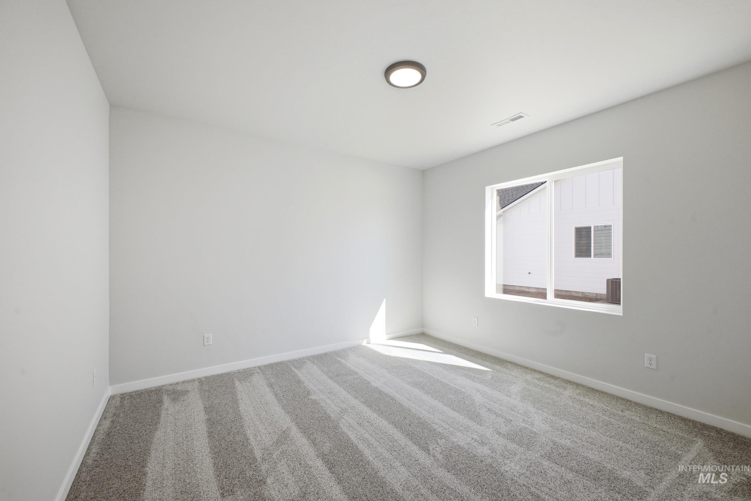 13633 Redway Court Caldwell, ID 83607 - Photo 17 of 29 Spare room featuring light carpet and baseboards