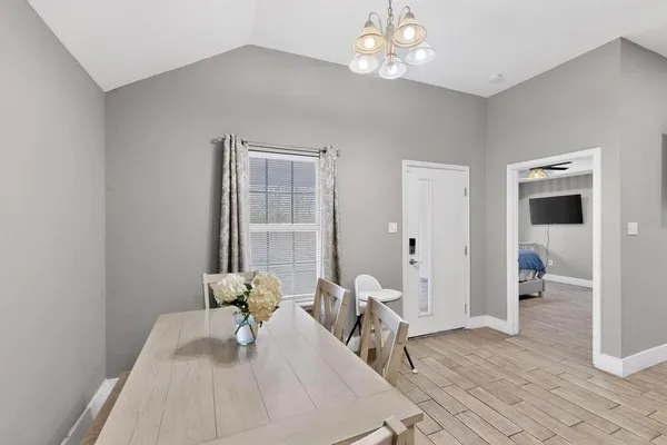a living room with furniture and a chandelier
