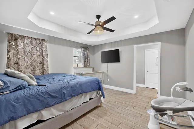 a bedroom with a bed and a television