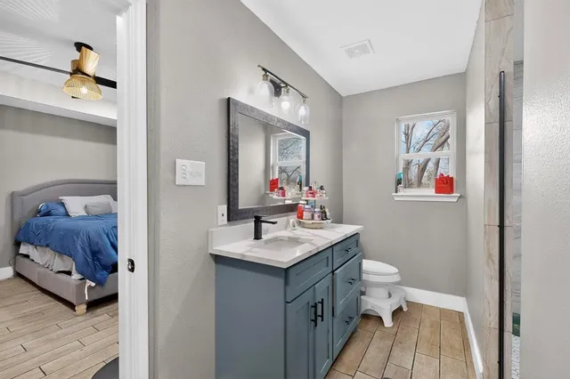 a en suite bathroom with a toilet sink and mirror