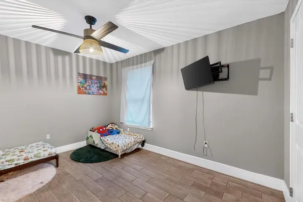 a bedroom with a bed and a tv