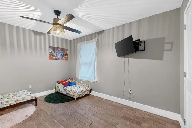 a bedroom with a bed and a tv