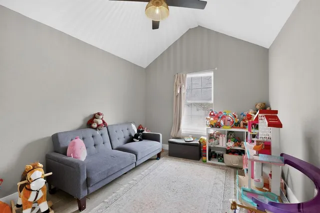 a bed room with couch and a window