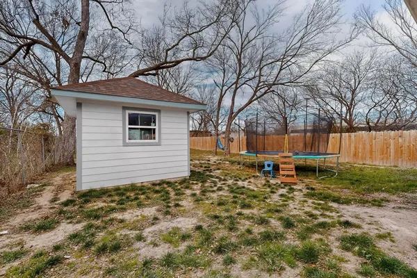 a backyard of a house with table and chairs