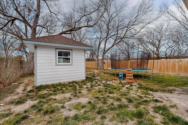 a backyard of a house with table and chairs