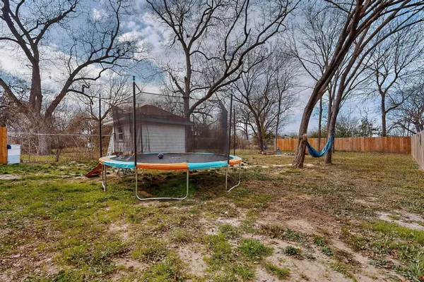 a backyard of a house with table and chairs