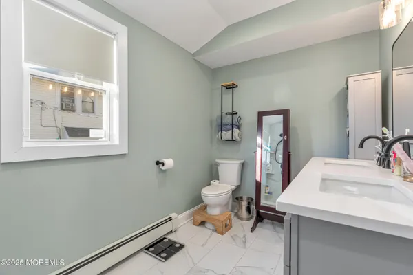 a bathroom with a sink toilet and a mirror