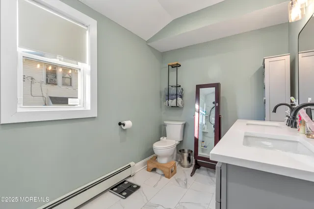 a bathroom with a sink toilet and a mirror