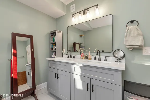 a bathroom with a sink vanity and mirror