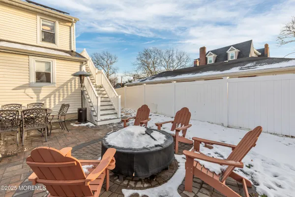a couple of chairs sitting in front of a house
