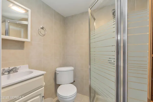 a white toilet sitting next to a bathroom sink