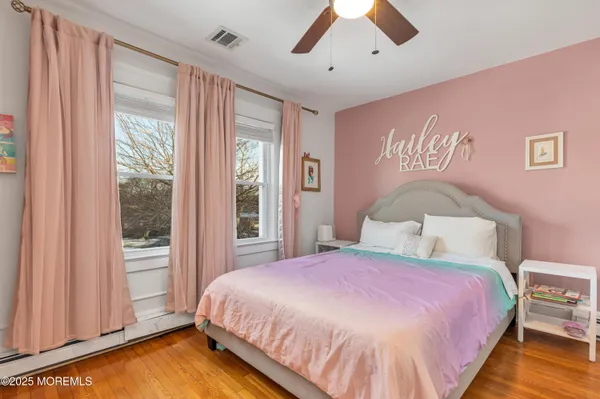 a spacious bedroom with a bed and a large window