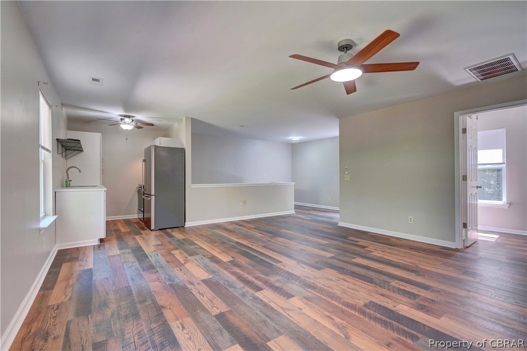 8269 Ark Road Gloucester, VA 23061 - Photo 11 of 33 Empty room with dark hardwood / wood-style floors, ceiling fan, and sink