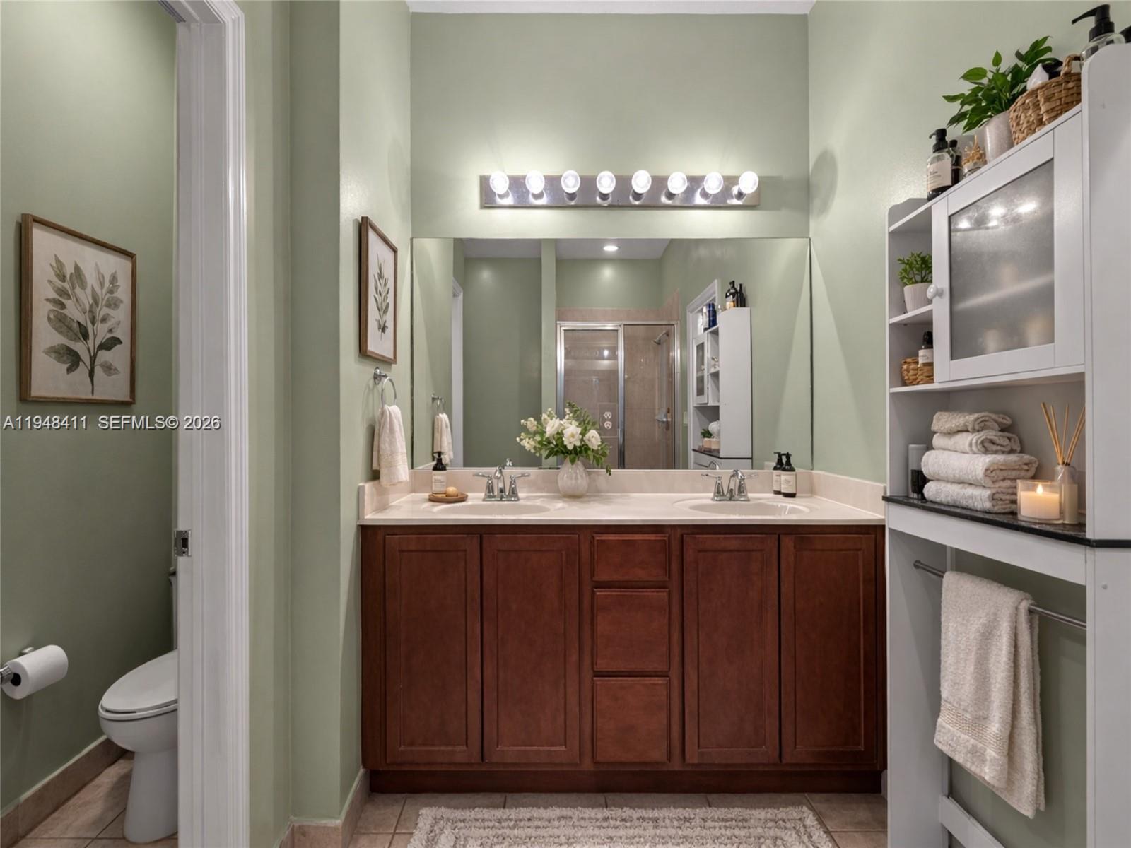 550 Northeast 33rd Terrace Homestead, FL 33033 - Photo 22 of 31 a bathroom with a double vanity sink and a toilet
