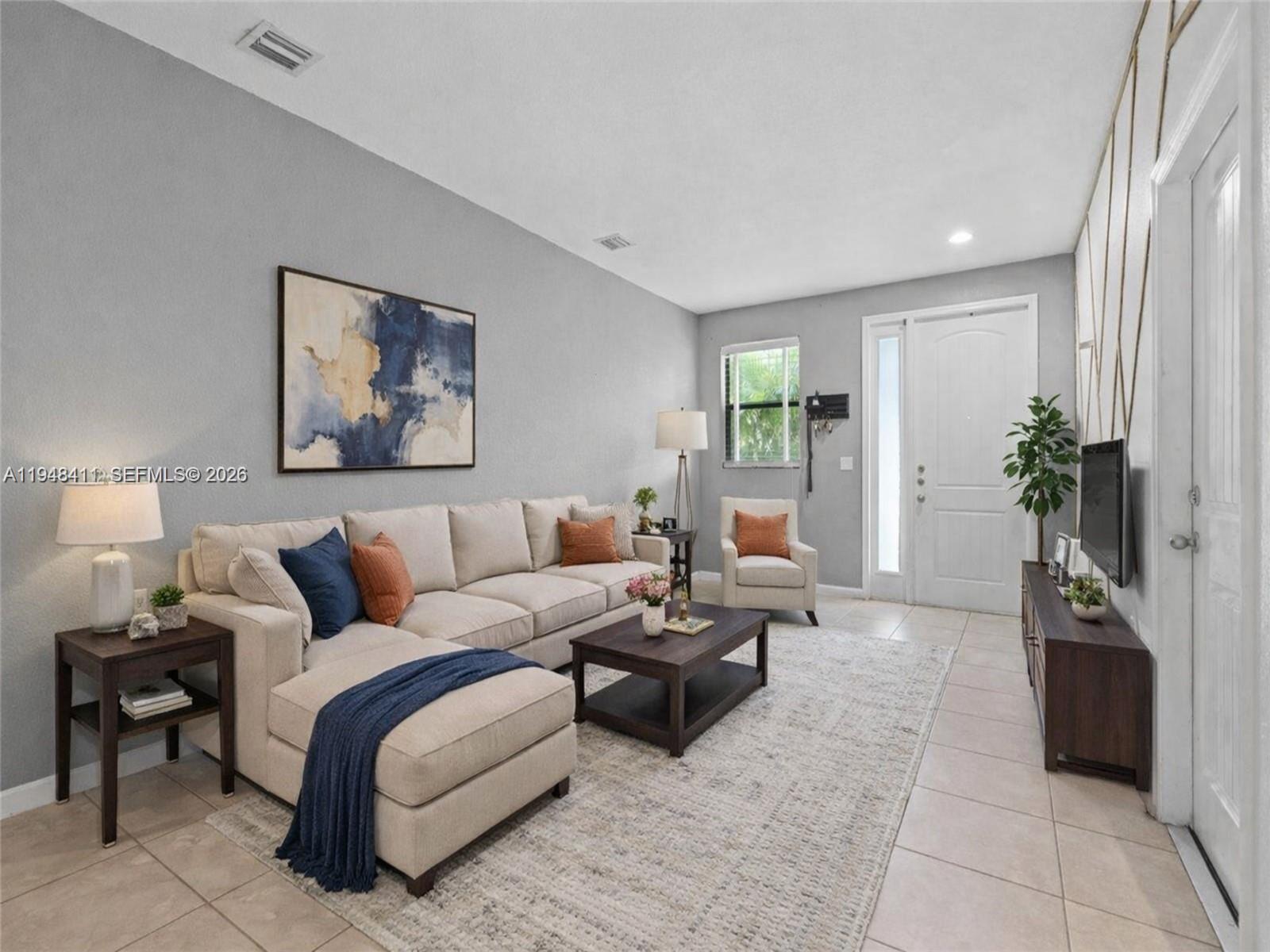 550 Northeast 33rd Terrace Homestead, FL 33033 - Photo 3 of 31 a living room with furniture and a potted plant