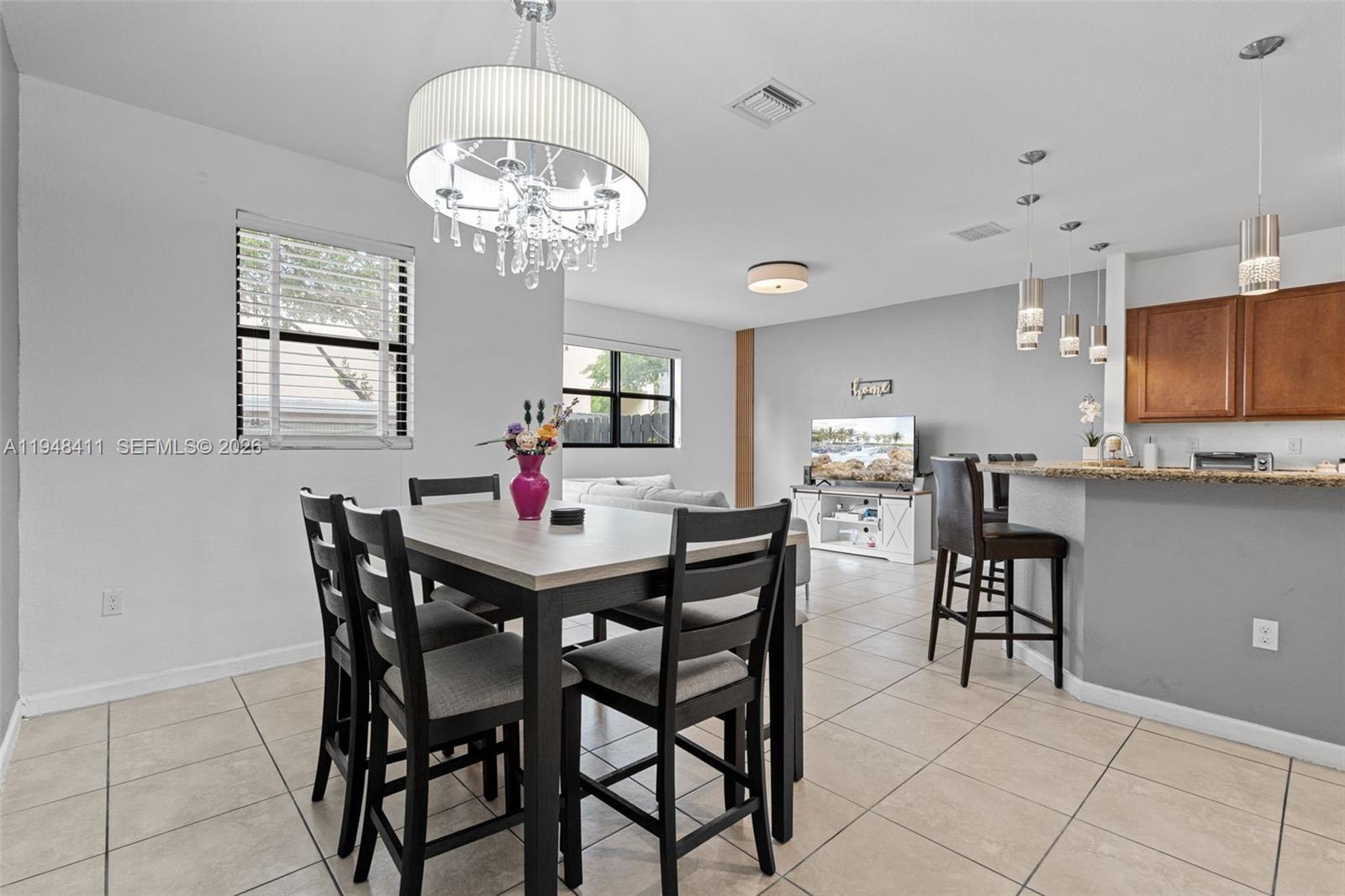 550 Northeast 33rd Terrace Homestead, FL 33033 - Photo 5 of 31 a view of a dining room with furniture and a chandelier