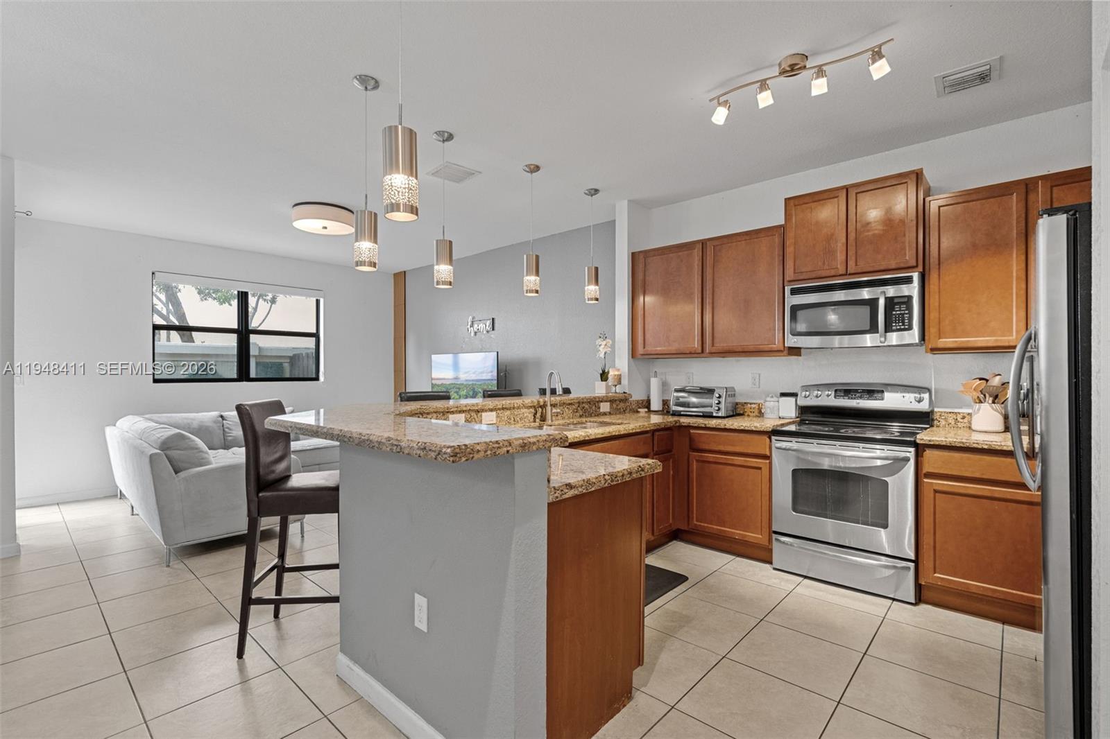 550 Northeast 33rd Terrace Homestead, FL 33033 - Photo 7 of 31 a kitchen with cabinets appliances and a dining table