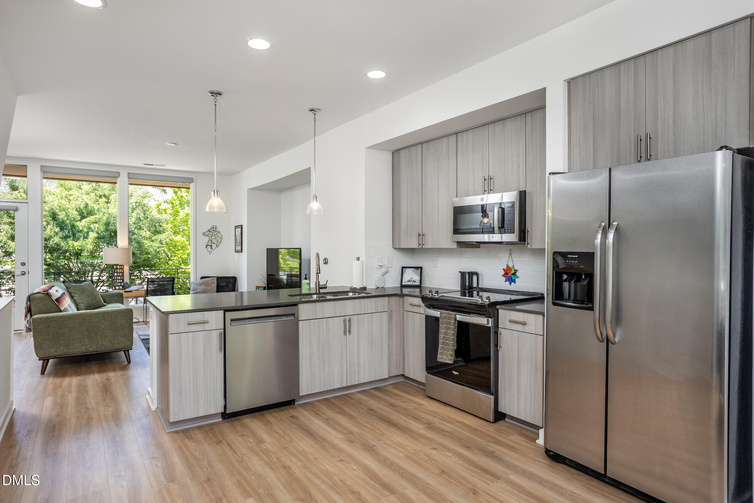 536 South Person Street Raleigh, NC 27601 - Photo 20 of 31 a kitchen with stainless steel appliances granite countertop a refrigerator a sink dishwasher a stove top oven a refrigerator with white cabinets and wooden floor