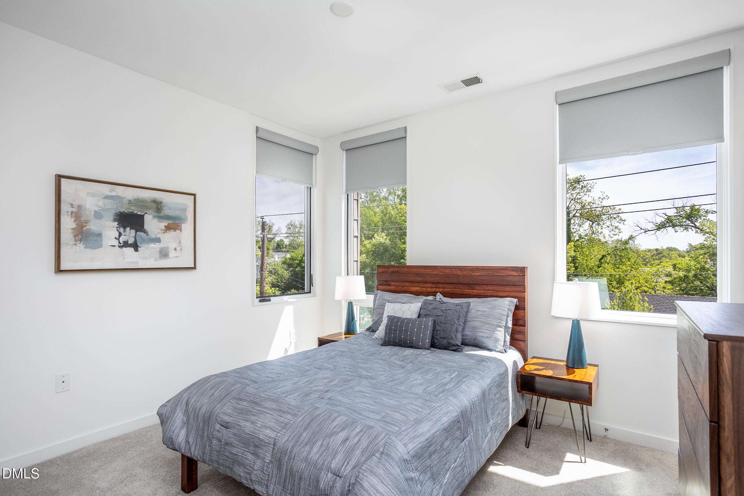 536 South Person Street Raleigh, NC 27601 - Photo 25 of 31 a bed sitting in a bedroom next to a window