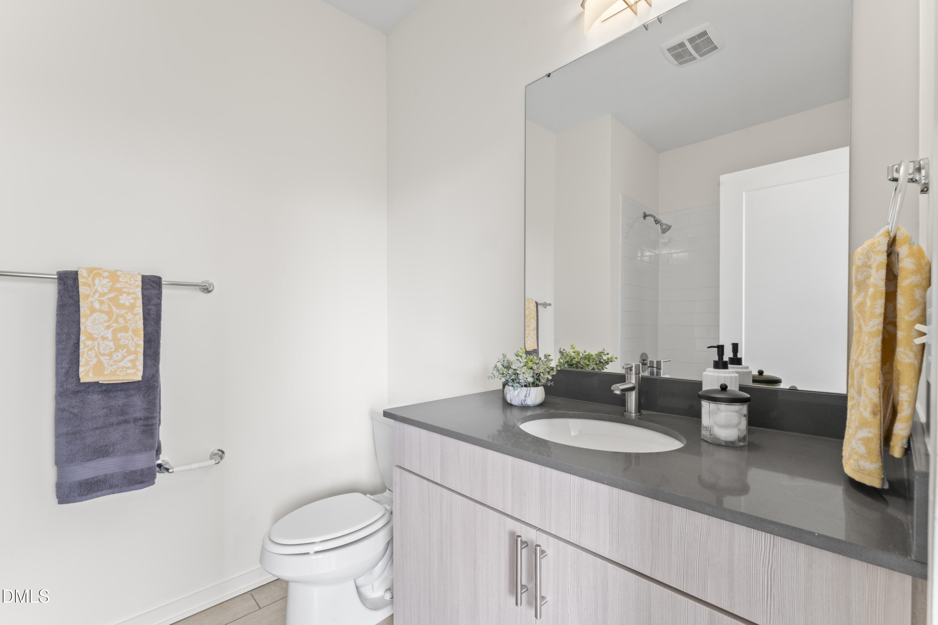 536 South Person Street Raleigh, NC 27601 - Photo 26 of 31 a bathroom with a granite countertop sink and a mirror