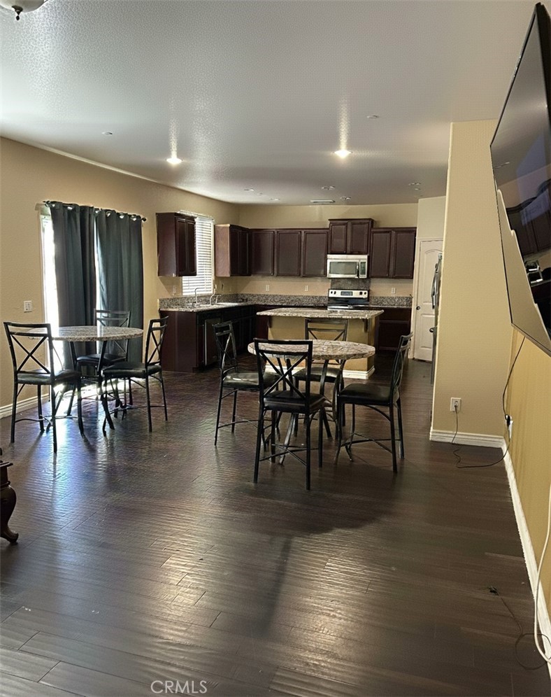 15068 Brucite Road Victorville, CA 92394 - Photo 4 of 10 a view of a dining area with furniture window and wooden floor
