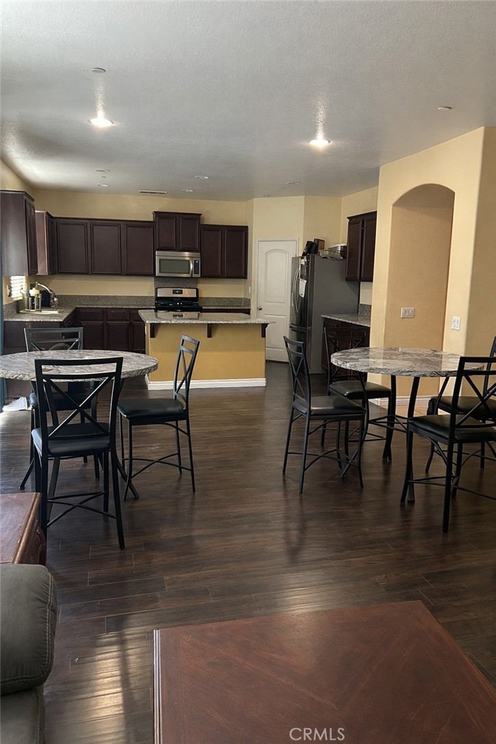 15068 Brucite Road Victorville, CA 92394 - Photo 5 of 10 a view of kitchen with furniture and wooden floor