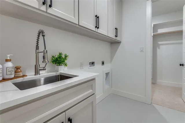 a view white cabinets and a sink