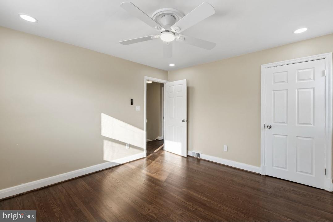 5102 Plymouth Road Baltimore, MD 21214 - Photo 12 of 32 a view of an empty room with wooden floor
