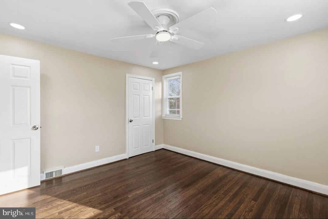 5102 Plymouth Road Baltimore, MD 21214 - Photo 13 of 32 wooden floor in an empty room with a window