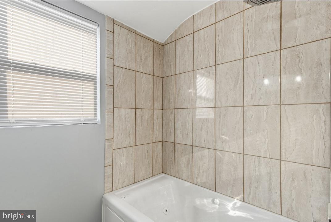 5102 Plymouth Road Baltimore, MD 21214 - Photo 19 of 32 a bathroom with a bathtub and shower