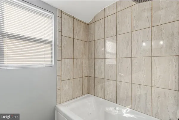 a bathroom with a bathtub and shower