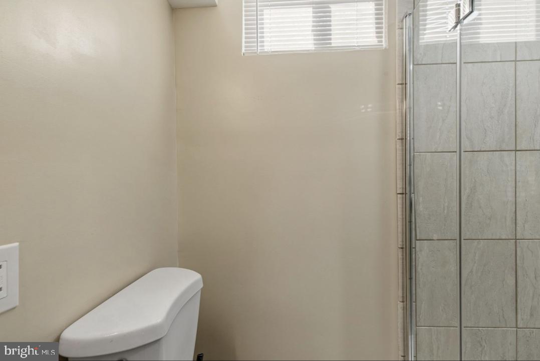 5102 Plymouth Road Baltimore, MD 21214 - Photo 22 of 32 a white toilet sitting next to a window