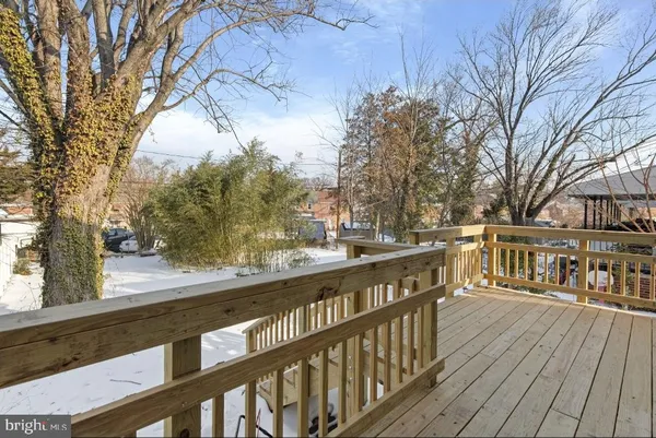 a view of a balcony with wooden floor and fence
