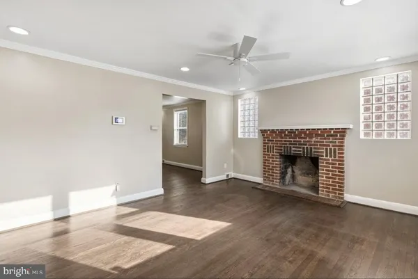 a view of an empty room with window and fire place