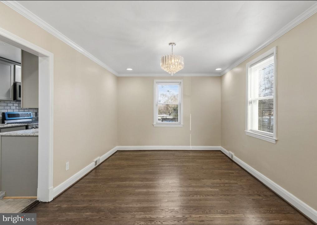 5102 Plymouth Road Baltimore, MD 21214 - Photo 7 of 32 an empty room with wooden floor and window