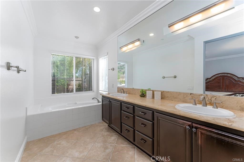 540 Boxcar Lane Brea, CA 92823 - Photo 17 of 36 a bathroom with a tub double vanity sink and mirror