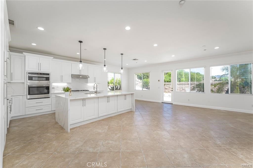 540 Boxcar Lane Brea, CA 92823 - Photo 9 of 36 a large kitchen with kitchen island a large counter top stainless steel appliances and cabinets