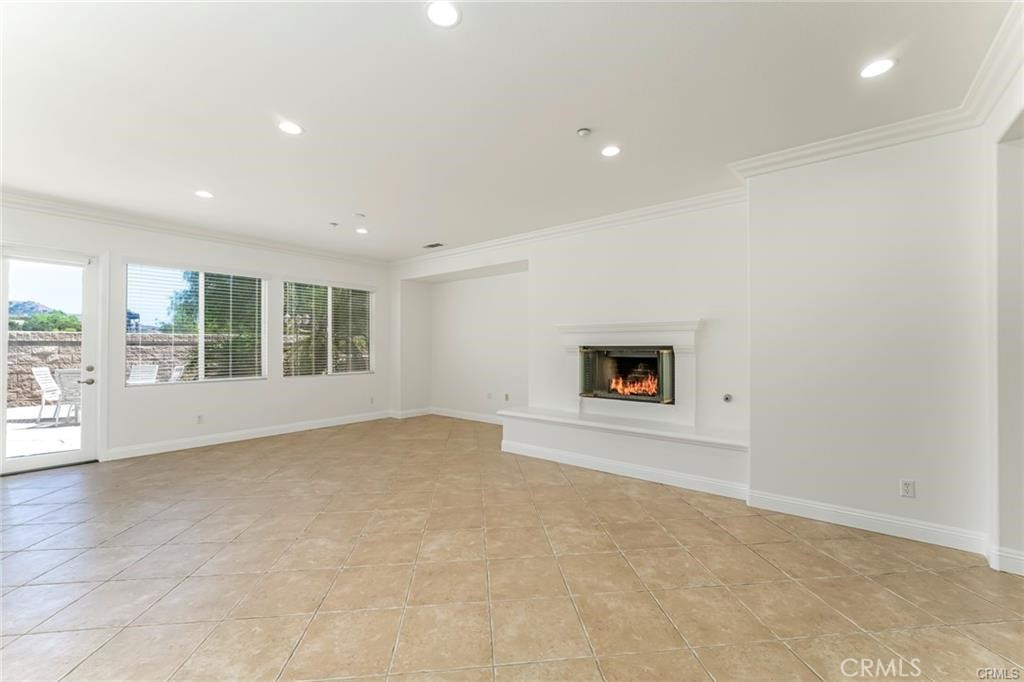 540 Boxcar Lane Brea, CA 92823 - Photo 10 of 36 an empty room with a fireplace and large window