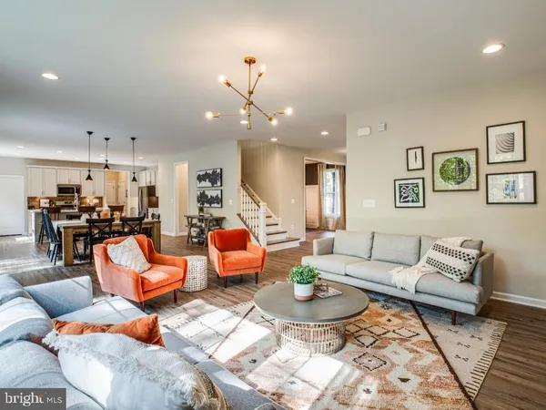 a living room with furniture kitchen view and a dining table