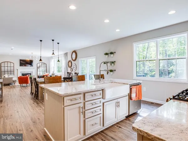 a large white kitchen with a large window