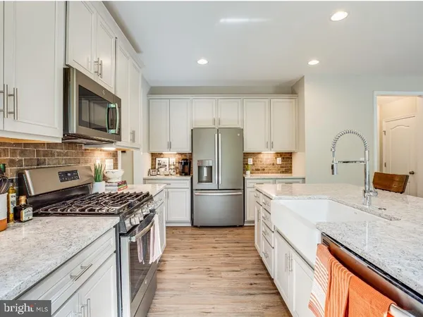 a kitchen with a sink stove and refrigerator