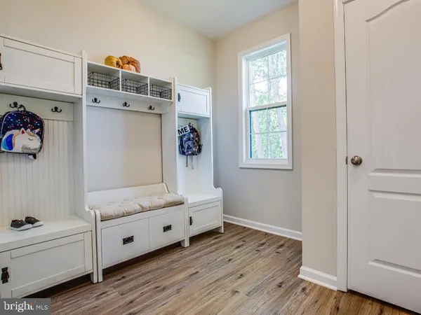 a room with a baby crib and a dresser