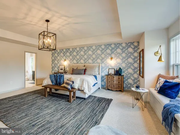a bedroom with furniture and a chandelier