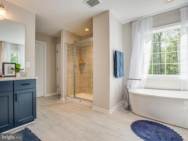 a bathroom with a tub shower and a sink