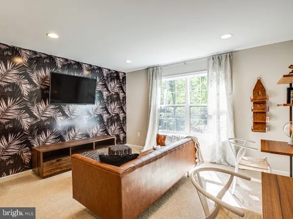a kitchen with a stove and a flat screen tv